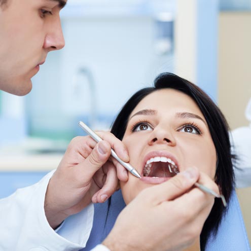 Dentist examining a patient mouth