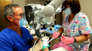 Doctor using microscopes for patient treatment